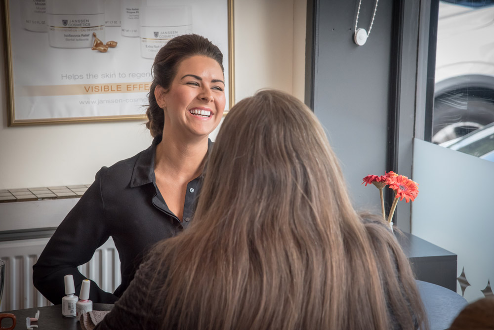A Serenity stylist laughing with a client during a consultation