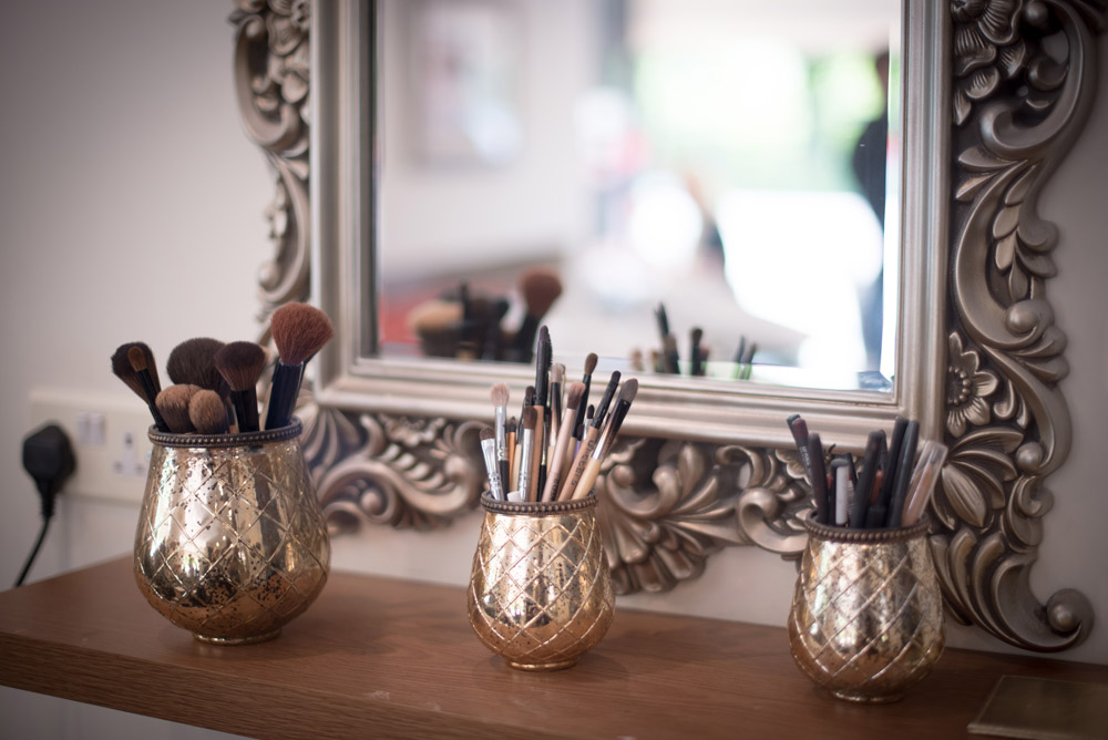 Make-up brushes in gold pots
